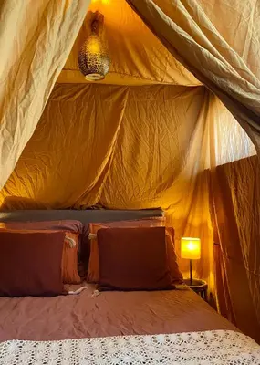a bedroom with a bed in a tent at Casa Calida in Warmenhuizen
