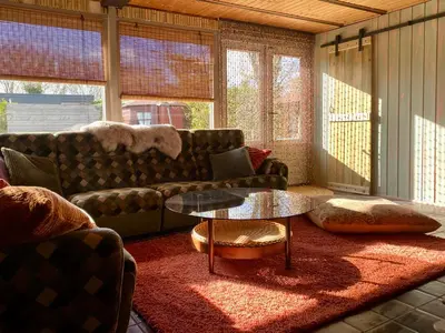 a living room with a couch and a table at Casa Calida in Warmenhuizen