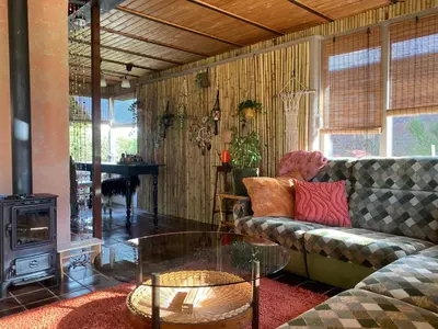 a living room with a couch and a glass table at Casa Calida in Warmenhuizen