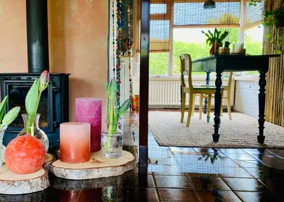 a living room with two candles and a table at Casa Calida in Warmenhuizen