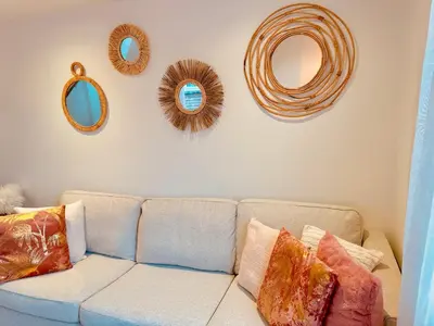 a living room with a couch and mirrors on the wall at Wellness at Sea in Egmond aan Zee