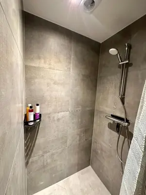 a bathroom with a shower with a shower head at Wellness at Sea in Egmond aan Zee