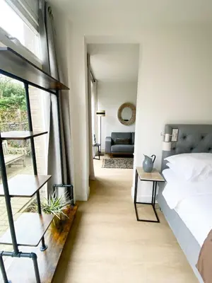a bedroom with a bed and a window at The East Wing Bloemendaal in Bloemendaal