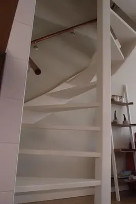 a white staircase in a room with shelves at Have a nice stay! - Zomerhuis Toda Cambia dicht bij strand in Noordwijk aan Zee