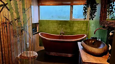 a bathroom with a large tub and a sink at Villa in the forest of Amsterdam with Pool in Velsen-Zuid