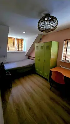 a room with green doors and a room with a table at Villa in the forest of Amsterdam with Pool in Velsen-Zuid