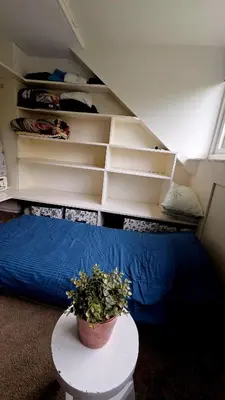 a room with a bed and a plant on a table at Villa in the forest of Amsterdam with Pool in Velsen-Zuid