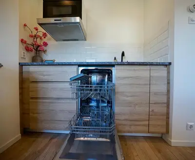 a dish washer sitting in a dishwasher in a kitchen at Maun Apartment in Zandvoort