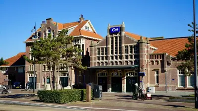 a large building with a flag on top of it at Maun Apartment in Zandvoort