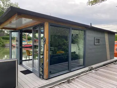 a cabin on a boat on the water at Houseboat De Amstel in Monnickendam
