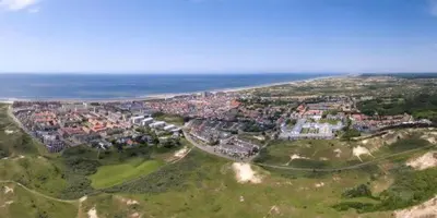 an aerial view of a town next to the ocean at Studio aan Zee op 150 Meter van Strand in Egmond aan Zee