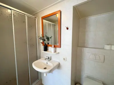 a bathroom with a sink and a shower at Studio aan Zee op 150 Meter van Strand in Egmond aan Zee
