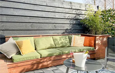 a couch sitting on a patio with a table at Stunning House In Spakenburg in Spakenburg