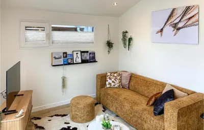 a living room with a couch and a tv at Stunning House In Spakenburg in Spakenburg
