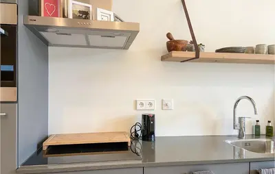 a kitchen with a sink and a counter top at Stunning House In Spakenburg in Spakenburg