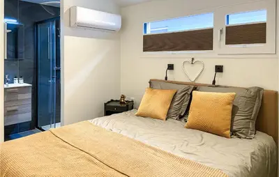 a bed with two pillows on it in a bedroom at Stunning House In Spakenburg in Spakenburg