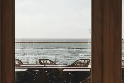a room with a view of the ocean through a window at Boutique Hotel Blendin Bloemendaal aan Zee in Bloemendaal Aan Zee