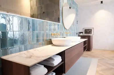 a bathroom with two sinks and a mirror at Boutique Hotel Blendin Bloemendaal aan Zee in Bloemendaal Aan Zee
