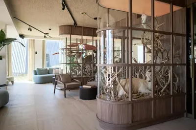 a lobby with a room with animals in a cage at Boutique Hotel Blendin Bloemendaal aan Zee in Bloemendaal Aan Zee