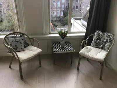 two chairs and a table in front of a window at Frank’s and Chong’s excellent location in Amsterdam