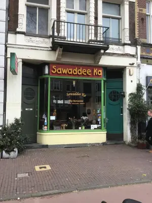 a store with a green door on a street at Frank’s and Chong’s excellent location in Amsterdam