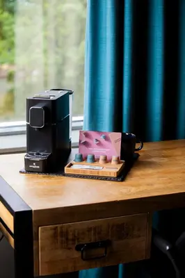 a coffee maker and a box on a table at Rooms25 in Amsterdam
