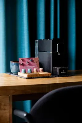a coffee maker sitting on a wooden table next to at Rooms25 in Amsterdam