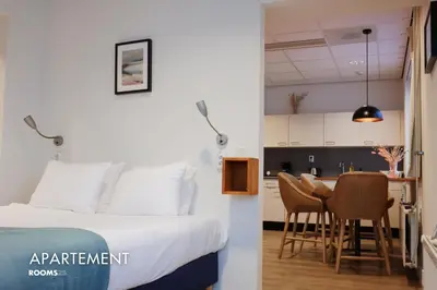 a hotel room with a bed and a table and chairs at Rooms25 in Amsterdam