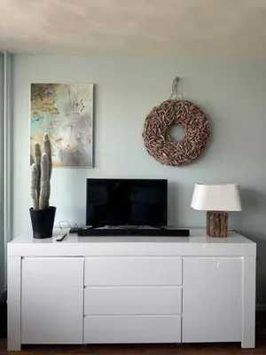 a white dresser with a tv on top of it at Apartment Fleurette in Zandvoort
