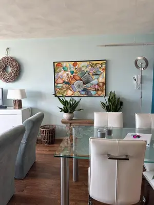 a dining room with a glass table and chairs at Apartment Fleurette in Zandvoort