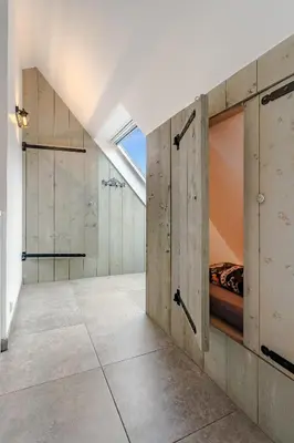 a bedroom with a bed and a skylight at Luxury apartment in farmhouse near Amsterdam in Ilpendam