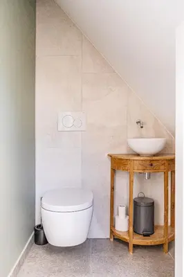 a bathroom with a toilet and a sink at Authentic apartment in farmhouse near Amsterdam in Ilpendam