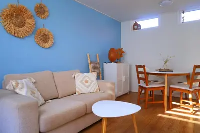 a living room with a couch and a table at Blue Wave in Egmond aan Zee