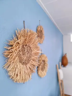 a teddy bear hanging on a blue wall at Blue Wave in Egmond aan Zee