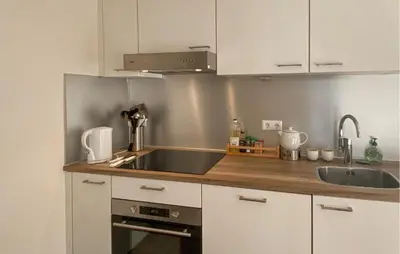 a kitchen with a sink and a counter top at Klein Maar Fijn in Bergen