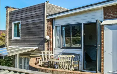 a patio with chairs and a table in front of a house at Pimpernel2 in Bergen aan Zee