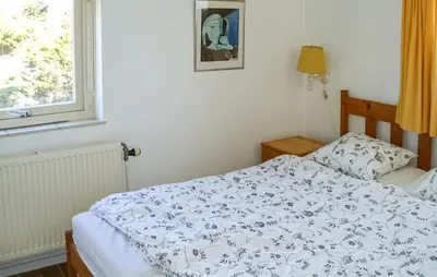 a bedroom with a bed and a window at Pimpernel2 in Bergen aan Zee