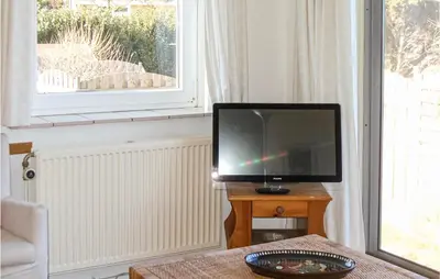 a television sitting on a table in a living room at Pimpernel2 in Bergen aan Zee