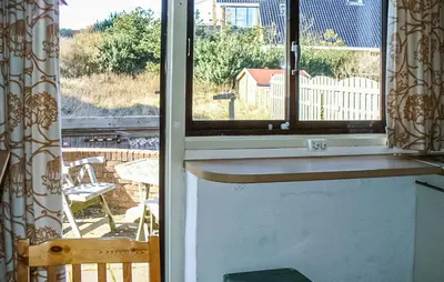 an open door to a balcony with a view of a patio at Pimpernel2 in Bergen aan Zee