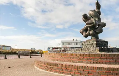 a statue of a plant on a brick wall at Villa By The Sea in Bergen aan Zee