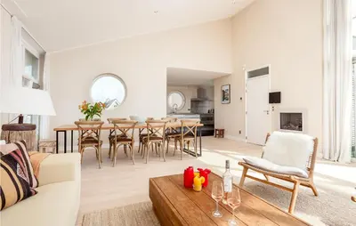 a living room with a couch and a table at Villa By The Sea in Bergen aan Zee
