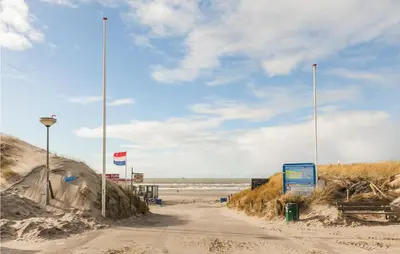 a dirt road next to a beach with the ocean at Villa By The Sea in Bergen aan Zee