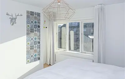 a bedroom with a bed and a window at Nautilus 1 in Bergen aan Zee