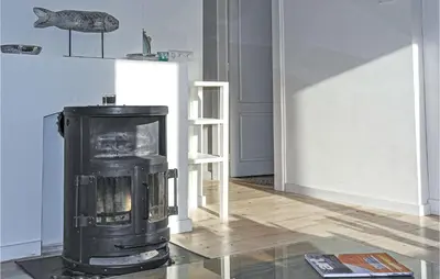 a living room with a black stove in a room at Nautilus 1 in Bergen aan Zee