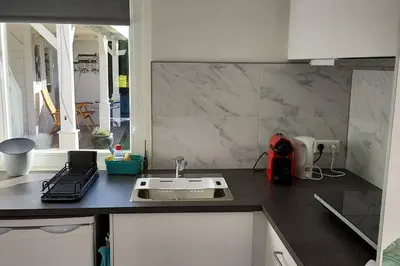 a kitchen with a sink and a counter top at Studio Dajan in Almere