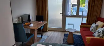 a living room with a desk and a couch at Studio Dajan in Almere