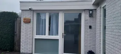 a white door on the side of a house at Studio Dajan in Almere
