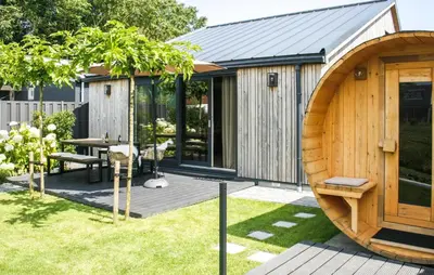 a wooden house with a large wooden door at Lovely Home In Oostwoud With Wifi in Oostwoud