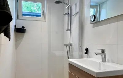 a white bathroom with a sink and a shower at Lovely Home In Oostwoud With Wifi in Oostwoud