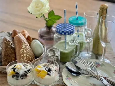 a table topped with plates and glasses of food at Life Contains Beautiful Things in Almere